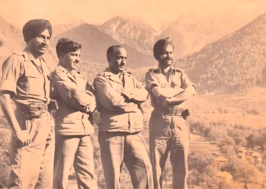 Second from right. (in the group of four)