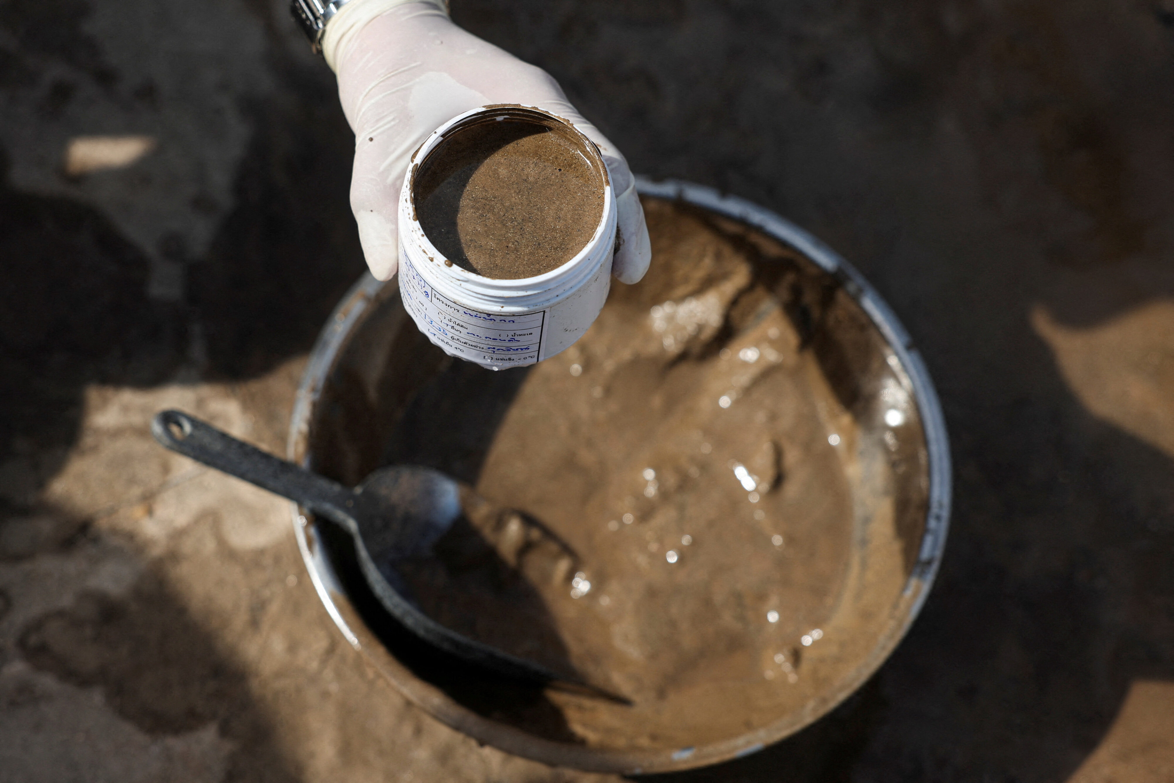 Samples from the Kok River in Tha Ton sub-district area are collected by Thailand's Pollution Control Department officers to test for heavy metal contamination. Reuters