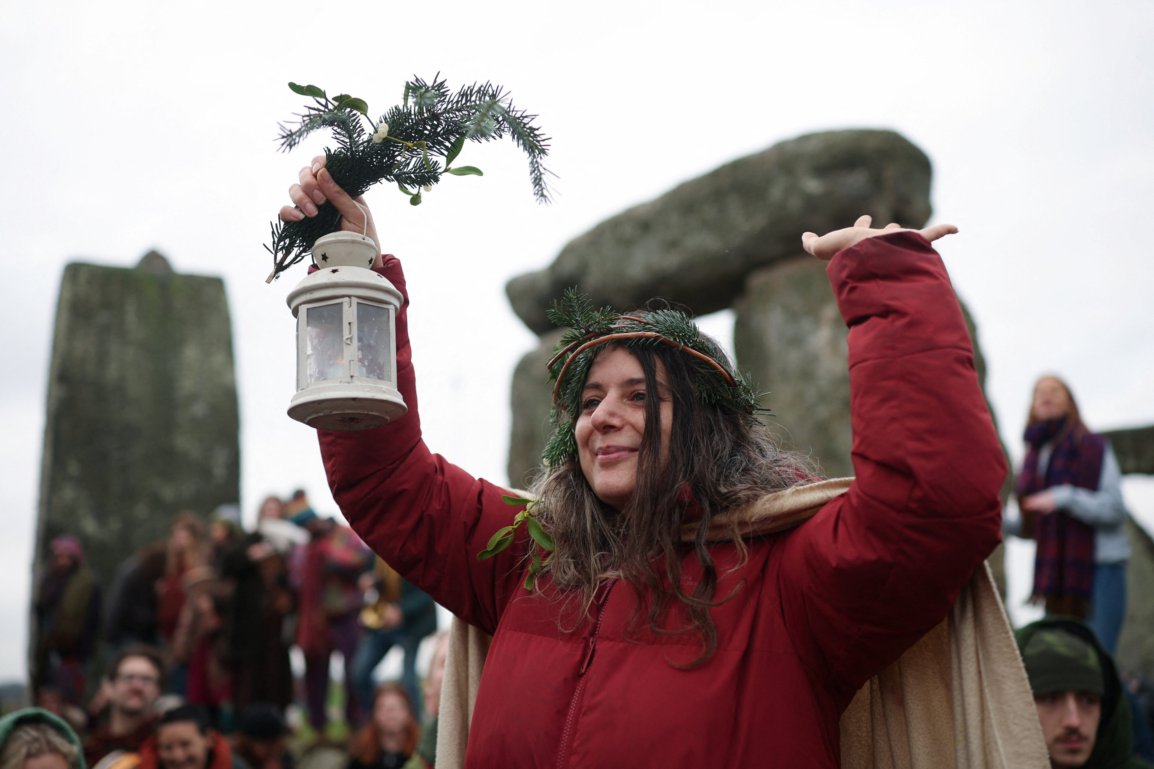 A woman gestures as revellers attend winter solstice celebrations at the Stonehenge stone circle. Reuters